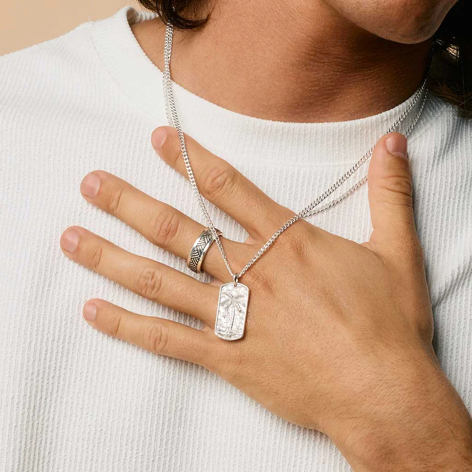Man wears Oasis Palm Tree necklace